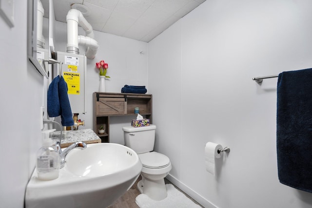 5466 Big Wolf Ln, Lewiston, MI 49756 - half bathroom with toilet and wood finished floors