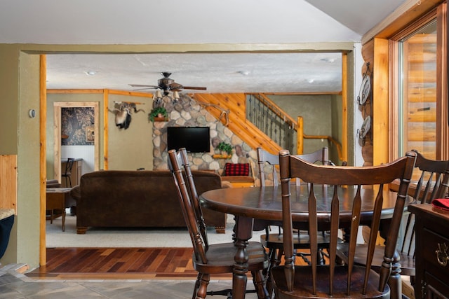 5466 Big Wolf Ln, Lewiston, MI 49756 - dining room featuring ceiling fan, vaulted ceiling, stairway, and wood walls