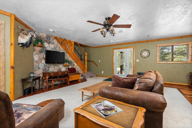 5466 Big Wolf Ln, Lewiston, MI 49756 - living area featuring plenty of natural light, a ceiling fan, wood finished floors, stairs, and a textured ceiling