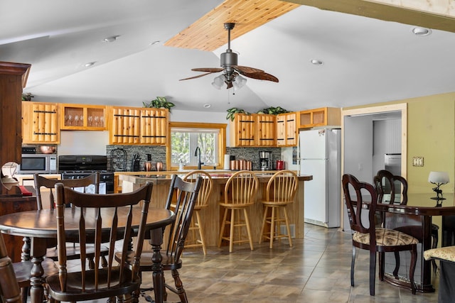 5466 Big Wolf Ln, Lewiston, MI 49756 - dining area featuring vaulted ceiling, ceiling fan, and recessed lighting