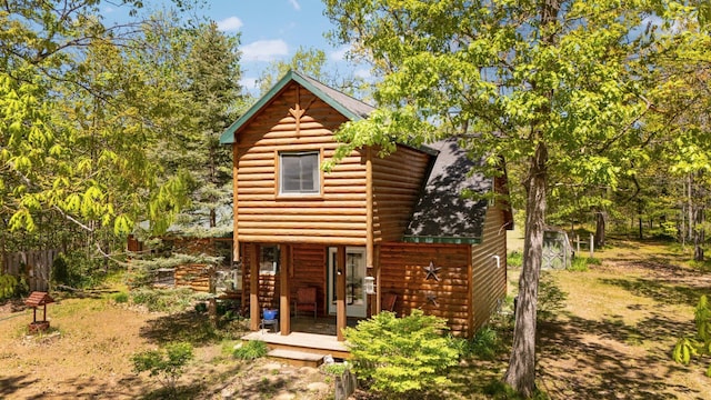5466 Big Wolf Ln, Lewiston, MI 49756 - rustic home featuring faux log siding