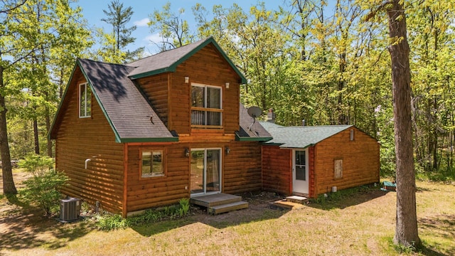 5466 Big Wolf Ln, Lewiston, MI 49756 - rear view of house featuring a shingled roof, a lawn, and log veneer siding