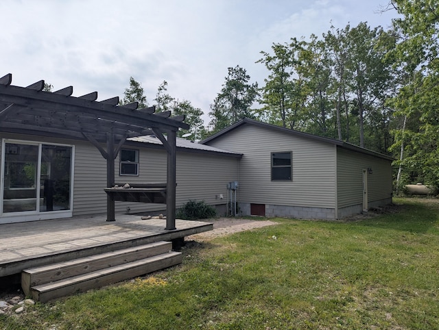 7322 E Grand Lake Rd, Presque Isle, MI 49777 - rear view of house featuring a deck, a pergola, and a lawn