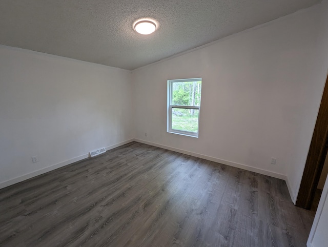 7322 E Grand Lake Rd, Presque Isle, MI 49777 - unfurnished room featuring a textured ceiling and dark wood finished floors