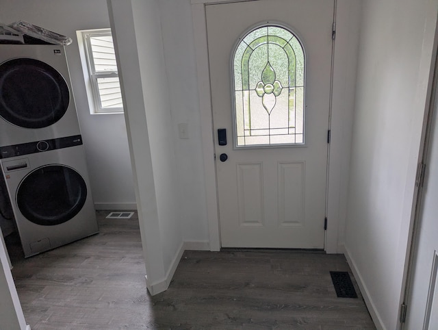 7322 E Grand Lake Rd, Presque Isle, MI 49777 - laundry area with estacked washer and dryer and wood finished floors