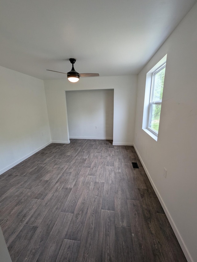 7322 E Grand Lake Rd, Presque Isle, MI 49777 - spare room featuring dark wood-style flooring and ceiling fan