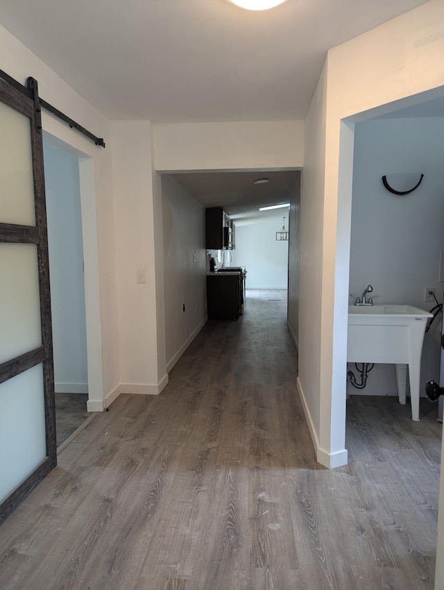 7322 E Grand Lake Rd, Presque Isle, MI 49777 - hallway with a barn door and wood finished floors