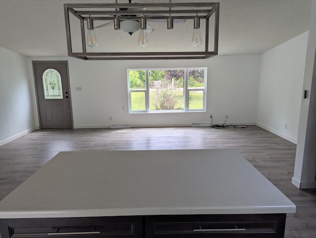 7322 E Grand Lake Rd, Presque Isle, MI 49777 - unfurnished living room with wood finished floors and a textured ceiling