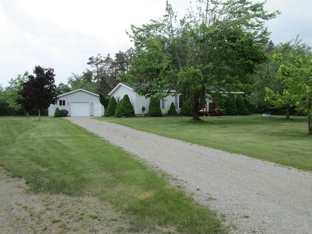 5189 Pinecrest Dr, Lewiston, MI 49756 - view of front of house with an outbuilding, a front yard, and a garage