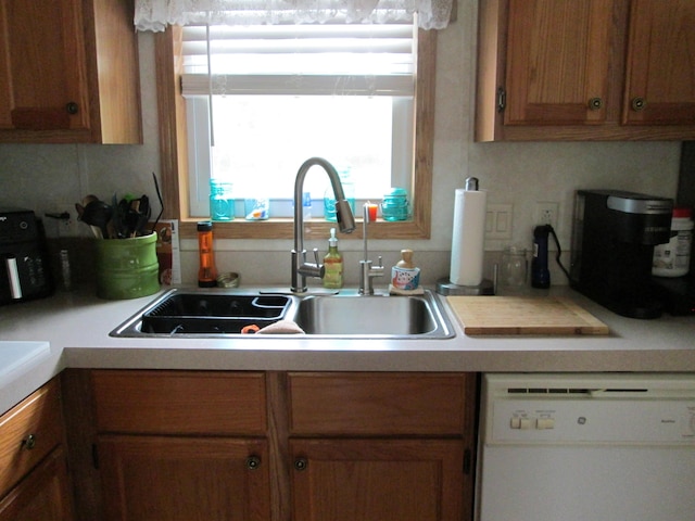 5189 Pinecrest Dr, Lewiston, MI 49756 - kitchen with dishwasher, a sink, light countertops, and brown cabinets
