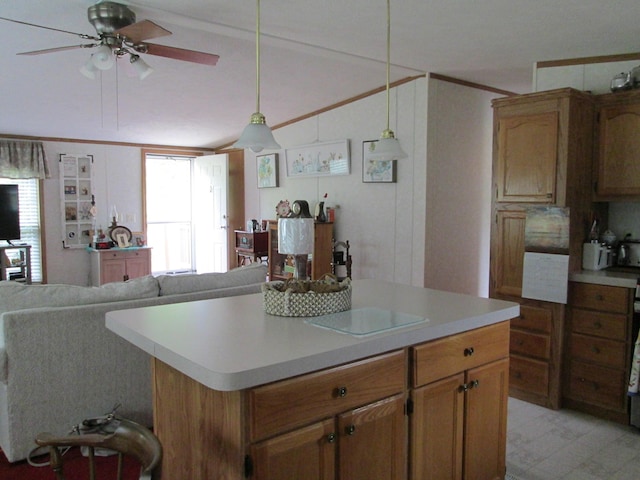 5189 Pinecrest Dr, Lewiston, MI 49756 - kitchen with a ceiling fan, light countertops, pendant lighting, crown molding, and open floor plan