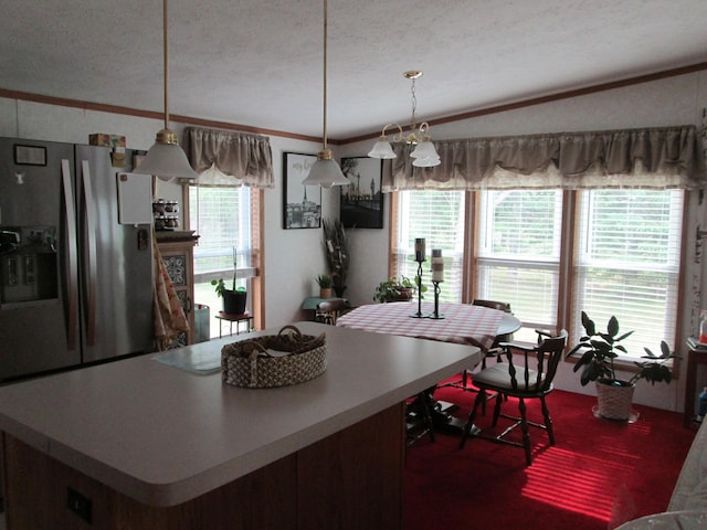 5189 Pinecrest Dr, Lewiston, MI 49756 - kitchen featuring stainless steel refrigerator with ice dispenser, ornamental molding, a textured ceiling, decorative light fixtures, and light countertops