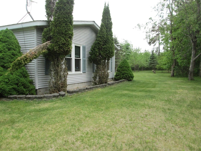 5189 Pinecrest Dr, Lewiston, MI 49756 - view of side of property featuring a lawn