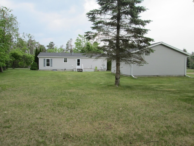 5189 Pinecrest Dr, Lewiston, MI 49756 - rear view of house featuring a lawn and crawl space