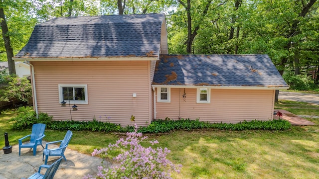 2303 Iroquois Ave, Prudenville, MI 48651 - view of home's exterior with a lawn and a shingled roof