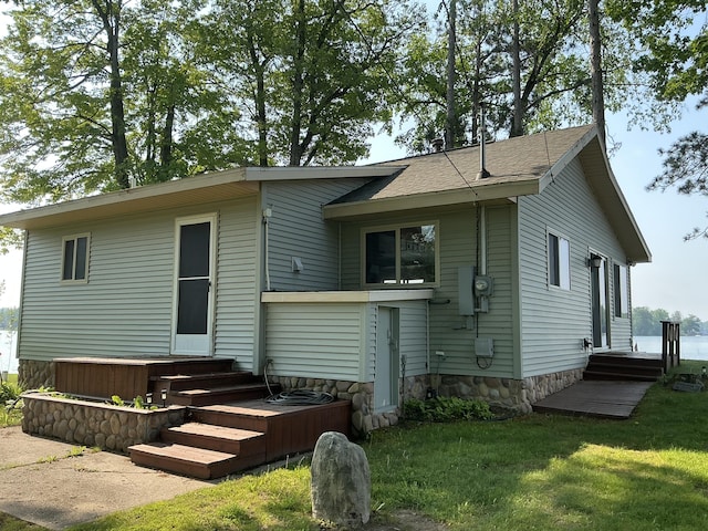 3606 S St, Lupton, MI 48635 - rear view of property with a lawn
