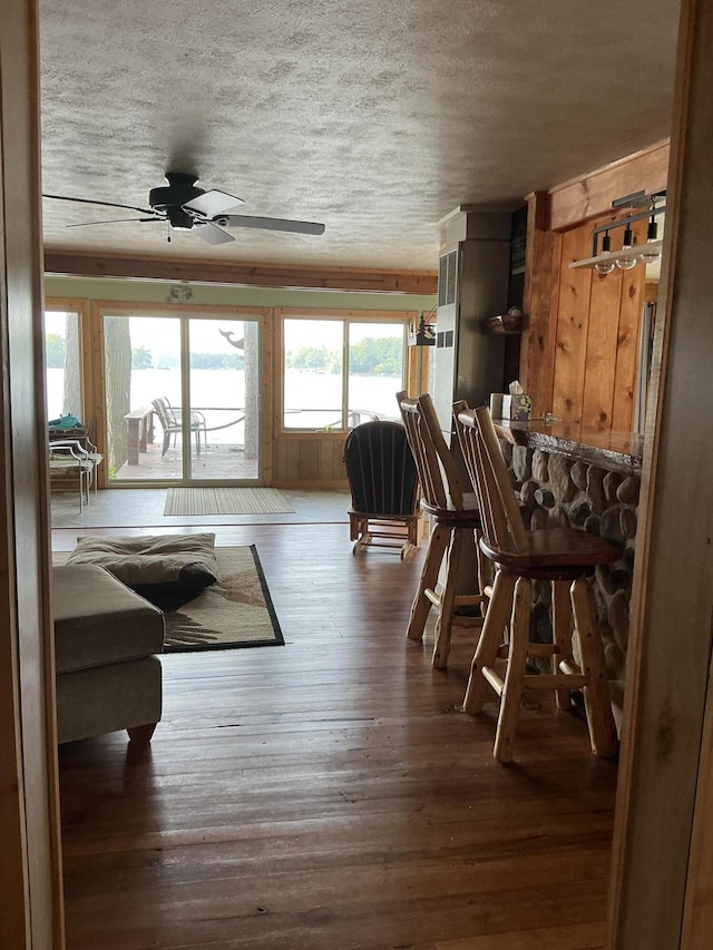 3606 S St, Lupton, MI 48635 - dining space featuring a ceiling fan, wood-type flooring, and a textured ceiling
