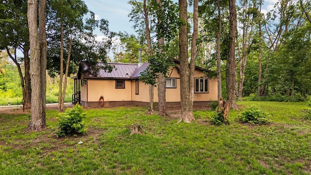 3065 E Dixon Lake Rd, Gaylord, MI 49735 - view of side of property with a metal roof and a lawn