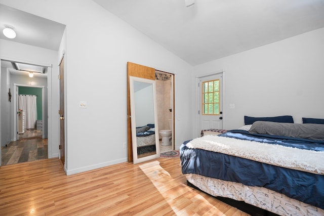 3065 E Dixon Lake Rd, Gaylord, MI 49735 - bedroom featuring lofted ceiling, light wood-style floors, attic access, and ensuite bathroom