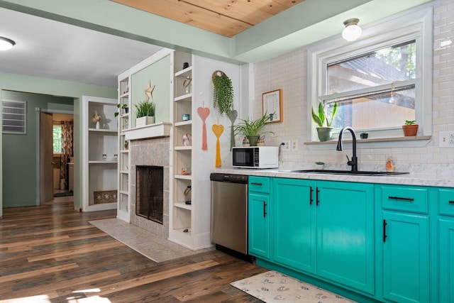 3065 E Dixon Lake Rd, Gaylord, MI 49735 - kitchen featuring stainless steel dishwasher, white microwave, dark wood finished floors, a tile fireplace, and plenty of natural light