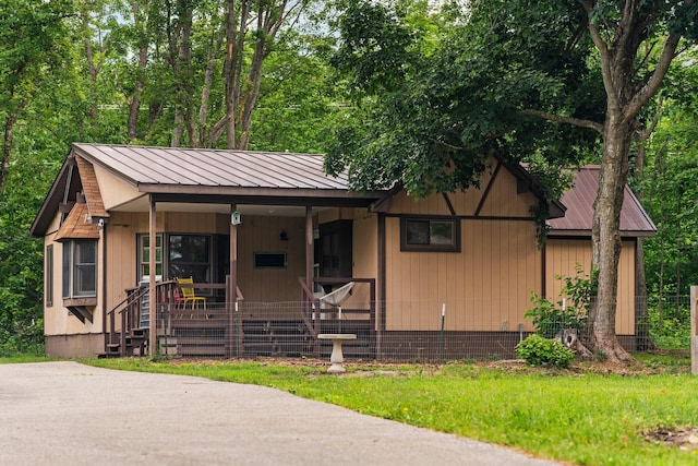 3065 E Dixon Lake Rd, Gaylord, MI 49735 - view of front facade featuring a metal roof and a porch