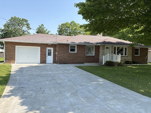 119 Kelly Rd, Alpena, MI 49707 - single story home with driveway, a front lawn, an attached garage, brick siding, and a shingled roof