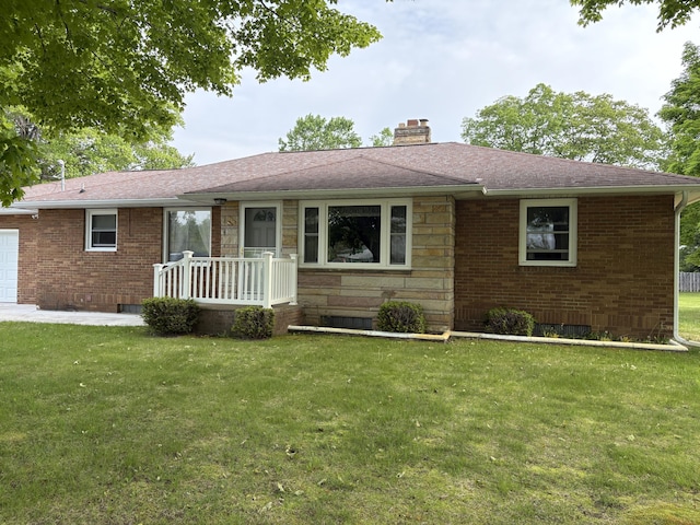 119 Kelly Rd, Alpena, MI 49707 - single story home featuring a chimney, a front yard, roof with shingles, brick siding, and a garage