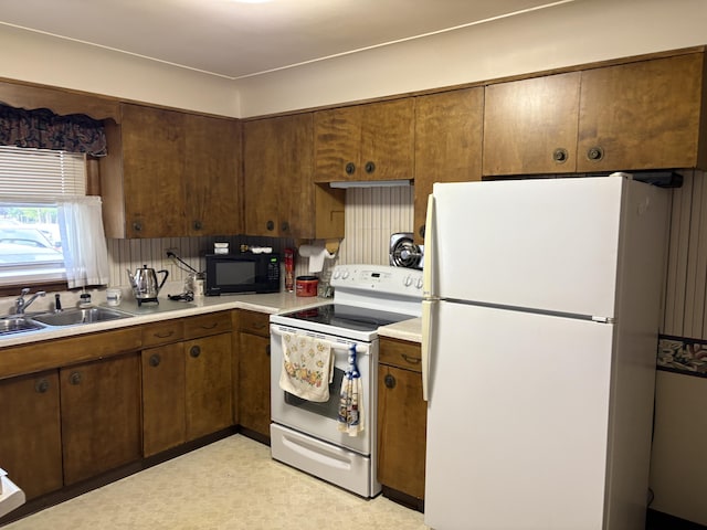 119 Kelly Rd, Alpena, MI 49707 - kitchen featuring white appliances, a sink, light countertops, and light flooring