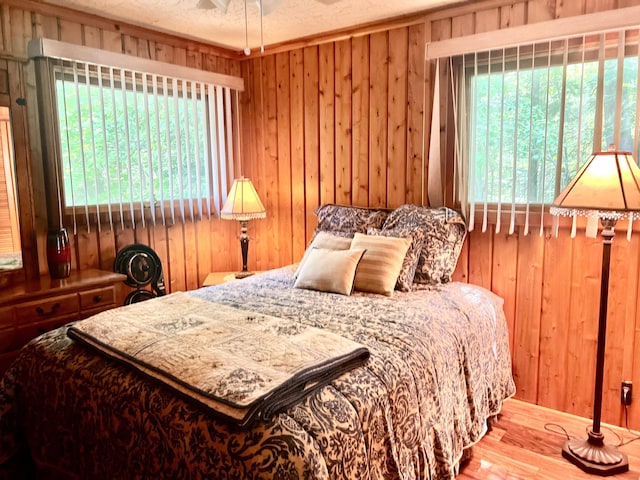7811 Mcdonald Rd, Cheboygan, MI 49721 - bedroom featuring wood walls and wood finished floors
