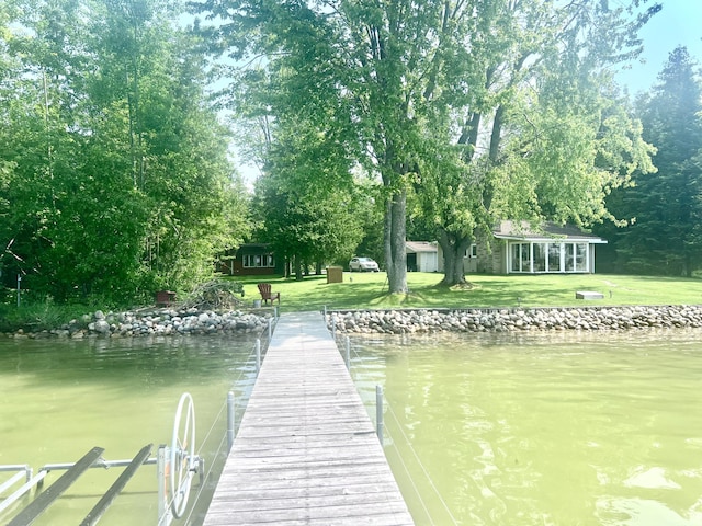 7811 Mcdonald Rd, Cheboygan, MI 49721 - dock with a lawn, a water view, and view of wooded area