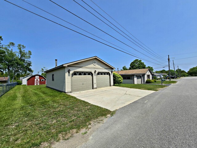 200 S 1st St, Saint Ignace, MI 49781 - view of front of home featuring an outbuilding and a detached garage