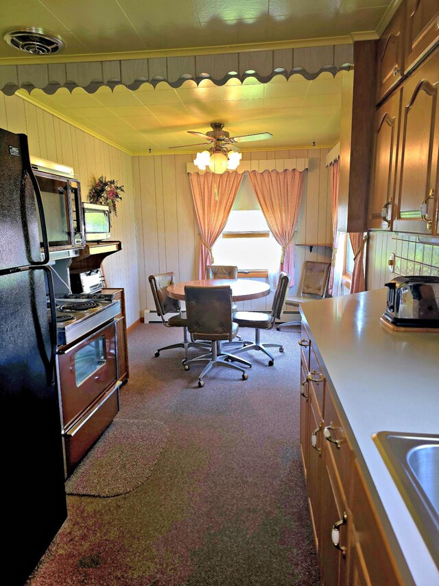 200 S 1st St, Saint Ignace, MI 49781 - kitchen with black appliances, dark colored carpet, ornamental molding, brown cabinetry, and a ceiling fan