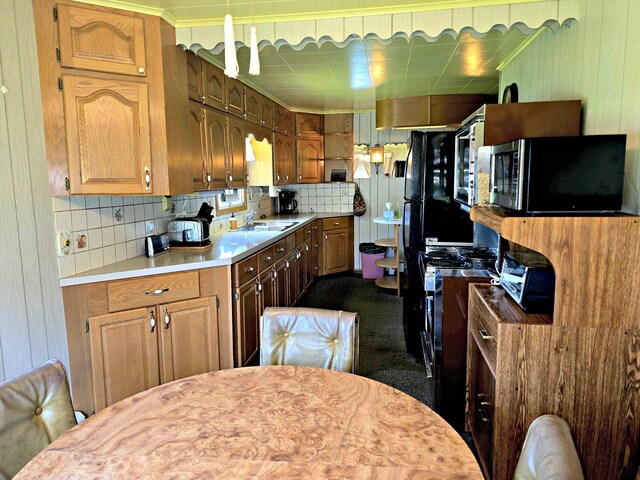 200 S 1st St, Saint Ignace, MI 49781 - kitchen with black microwave, light countertops, and tasteful backsplash