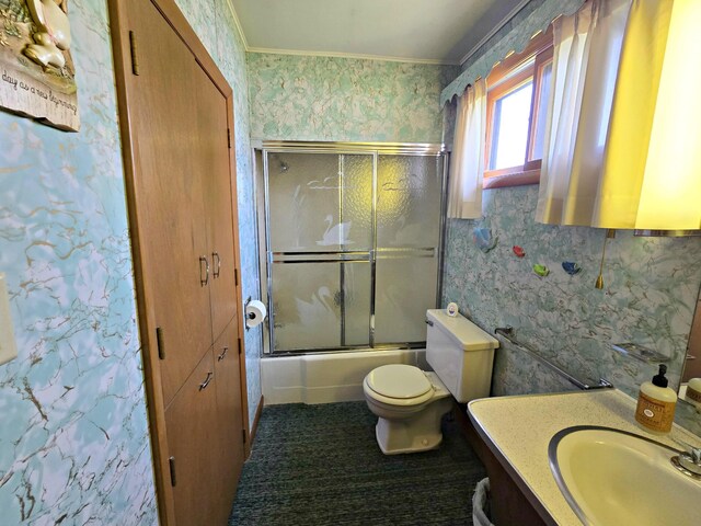 200 S 1st St, Saint Ignace, MI 49781 - bathroom featuring wallpapered walls, vanity, shower / bath combination with glass door, and crown molding