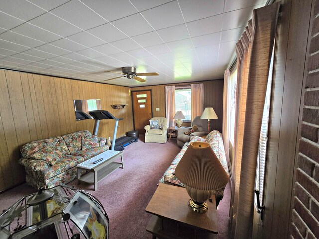 200 S 1st St, Saint Ignace, MI 49781 - carpeted living area featuring wooden walls and ceiling fan
