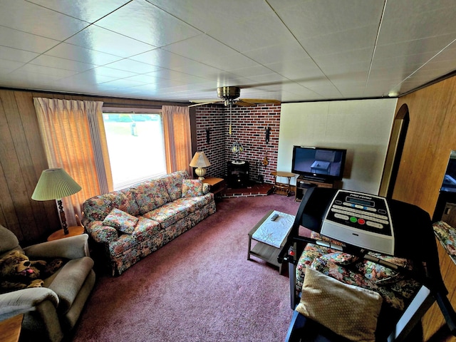 200 S 1st St, Saint Ignace, MI 49781 - living area featuring carpet, a wood stove, a ceiling fan, wooden walls, and arched walkways
