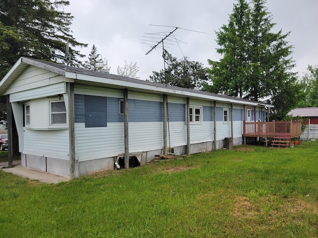 14089 M65, Posen, MI 49776 - rear view of property featuring a deck and a lawn