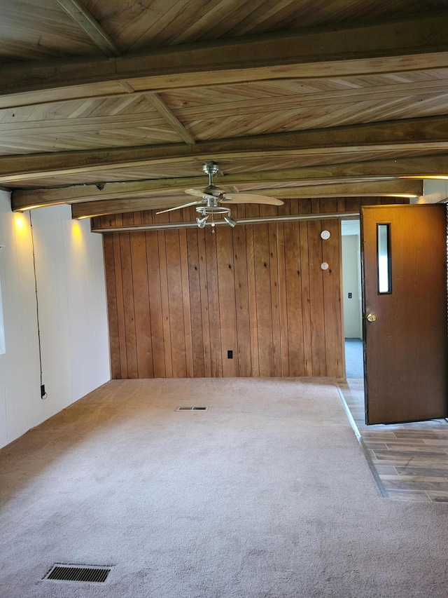 14089 M65, Posen, MI 49776 - spare room featuring carpet flooring, ceiling fan, and wood walls