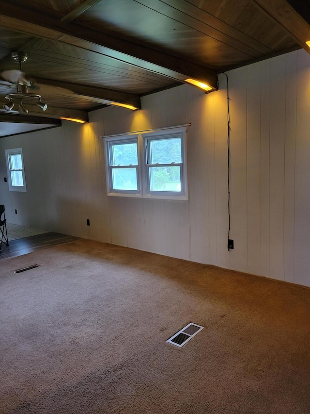 14089 M65, Posen, MI 49776 - spare room with carpet flooring, a ceiling fan, wood walls, and wooden ceiling with exposed beams