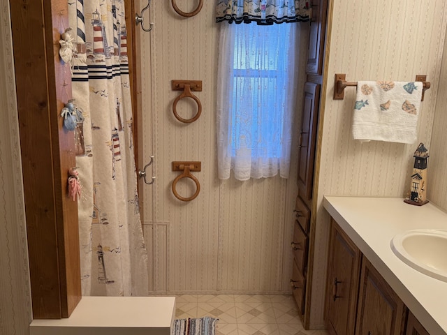 3981 Pointe Dr, Carp Lake, MI 49718 - full bath with wallpapered walls and vanity
