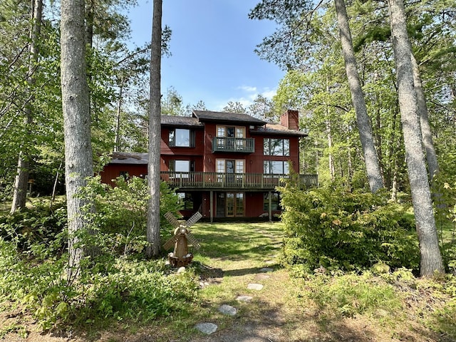 9561 Highbanks Dr, Cheboygan, MI 49721 - back of property with a chimney, french doors, and a deck