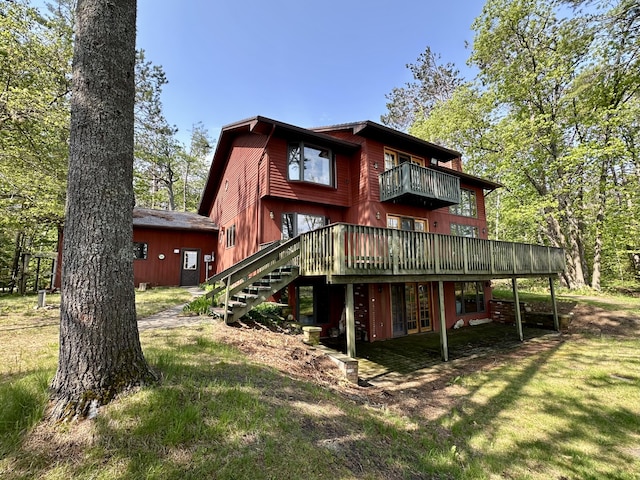 9561 Highbanks Dr, Cheboygan, MI 49721 - back of house featuring stairway, a yard, a balcony, and a wooden deck