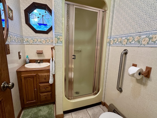 9561 Highbanks Dr, Cheboygan, MI 49721 - bathroom with wallpapered walls, a stall shower, vanity, a wainscoted wall, and tile patterned floors
