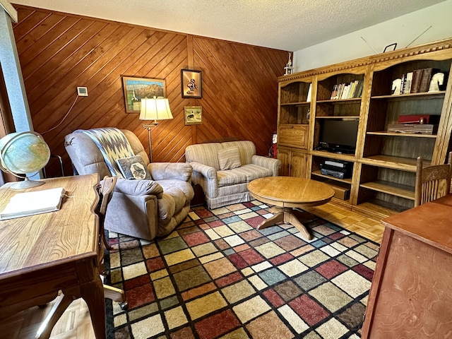 9561 Highbanks Dr, Cheboygan, MI 49721 - living area featuring a textured ceiling and wood walls