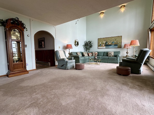 9561 Highbanks Dr, Cheboygan, MI 49721 - carpeted living area with arched walkways, a baseboard heating unit, and a textured ceiling