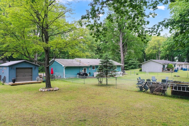 104 Alpena Trl, Houghton Lake, MI 48629 - fenced backyard with a detached garage and an outdoor structure