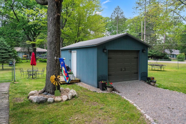 104 Alpena Trl, Houghton Lake, MI 48629 - detached garage with driveway and view of scattered trees