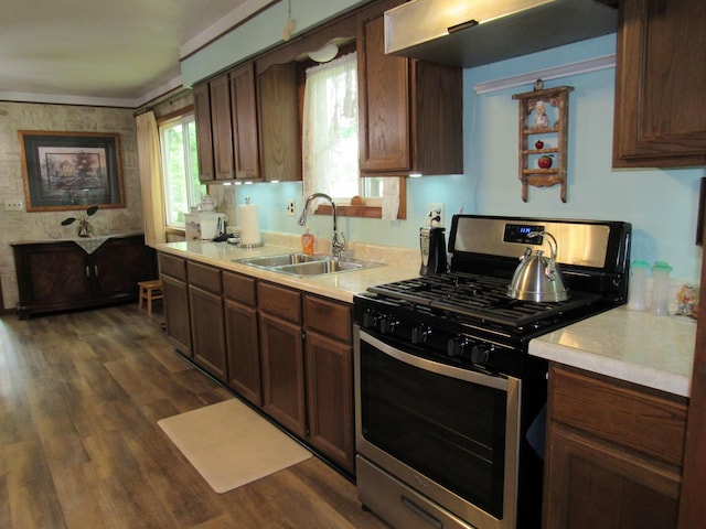110 Chippewa Trl, Prudenville, MI 48651 - kitchen with stainless steel range with gas cooktop, light countertops, dark wood-type flooring, and wallpapered walls