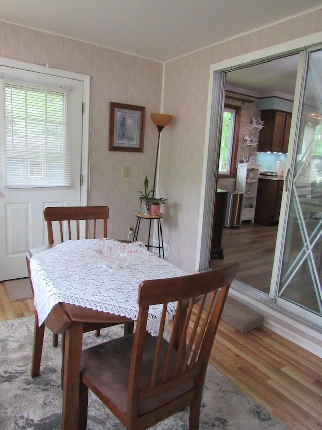 110 Chippewa Trl, Prudenville, MI 48651 - dining room featuring light wood-style flooring and ornamental molding