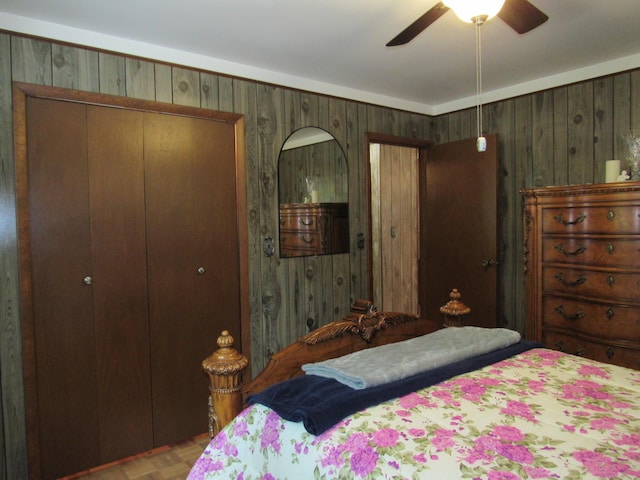 110 Chippewa Trl, Prudenville, MI 48651 - bedroom featuring a closet, wood walls, and ceiling fan